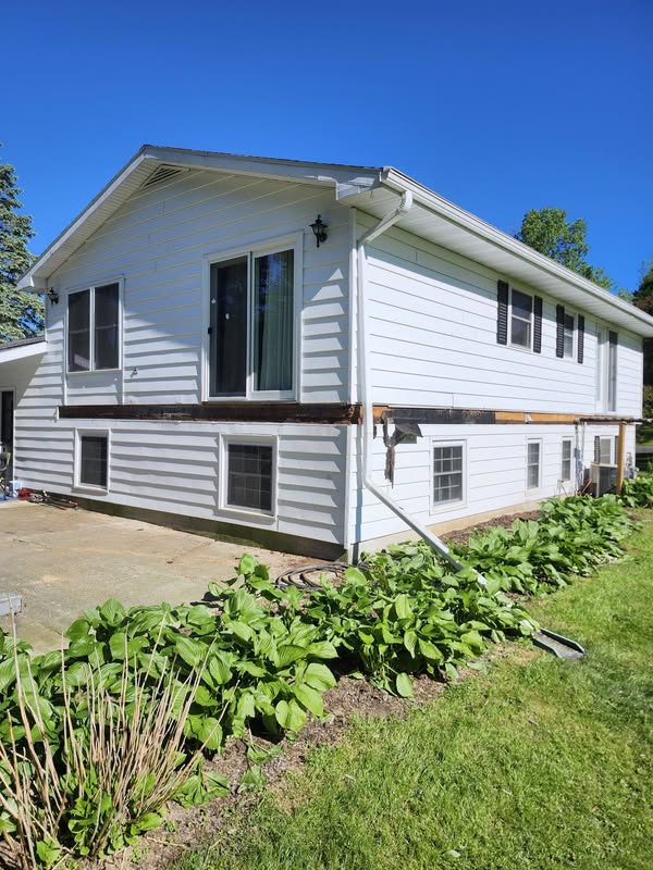 Deck ledger boards running along two sides of a white home