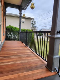 Porch boards with black railing and finished columns