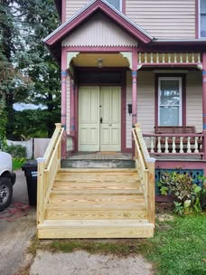 New front-entry stairs and wood railings on an older home